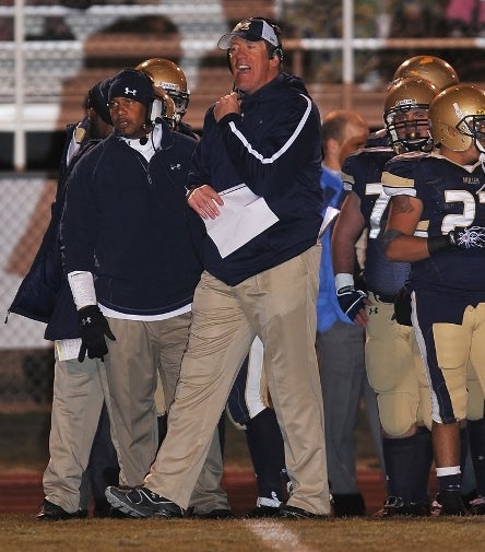 Former Mullen football coach Dave Logan, center, will take over the program at Cherry Creek, the state's largest high school.