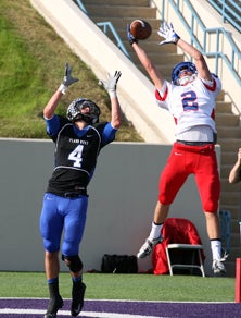 Westlake junior Derek Cohen goes
high to make a leaping interception
in the end zone.