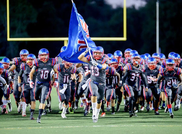 The Clayton Valley Charter Eagles charge the field heading into their first game of the season at the Honor Bowl in Loomis.