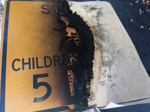 A mangled "Children at Play" sign across the street from Middletown High School.