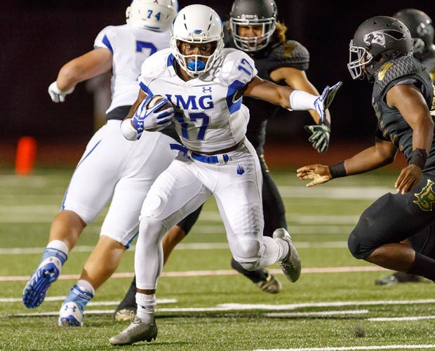 IMG Academy running back Trey Sanders attempts to elude a Long Beach Poly defender.