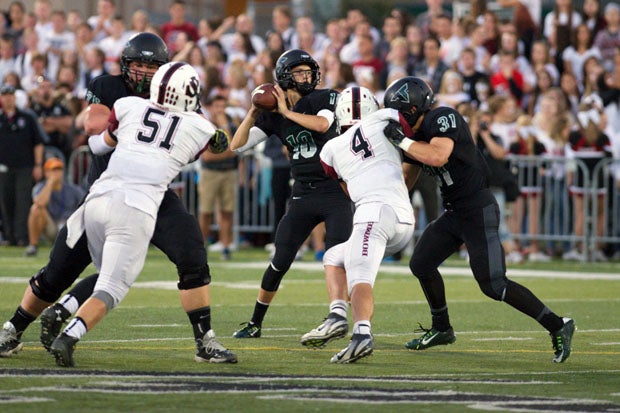 Tigard quarterback J.T. Greenough sits in a perfect pocket during a 49-28 home win over Sherwood on Sept. 19. Tigard is the MaxPreps Oregon Team of the Week, presented by the Oregon National Guard.
