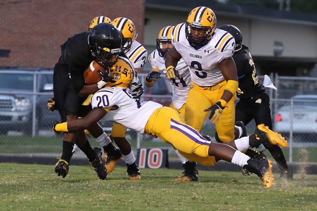 Columbia's Dariun Dallas (20) lays a big hit during the team's 59-0 win over Englewood on Friday. Dallas and his teammates have allowed only 44 points all season.