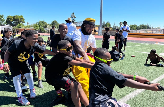 Marshawn Lynch gives a little pull in a tug-of-war competition at the end of the morning session.