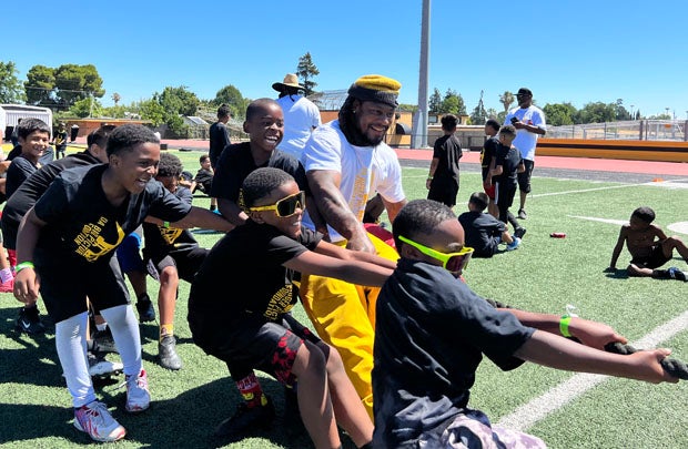 Marshawn Lynch gives a little pull in a tug-of-war competition at the end of the morning session. 