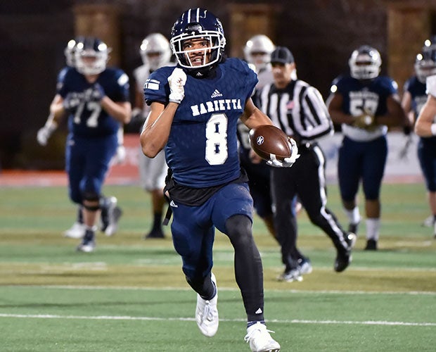 Receiver Taji Johnson breaks into the open while scoring one of his three touchdowns.