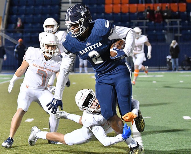 Tight end Arik Gilbert attempts to avoid an Eastside Catholic defender.