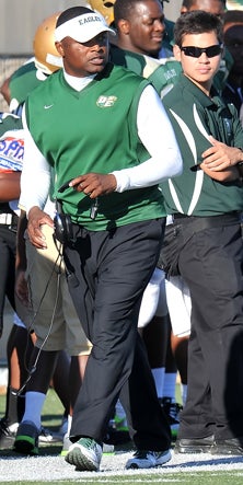 Claude Mathis paces the sideline
Saturday during his team's 46-27
win over Jenks.