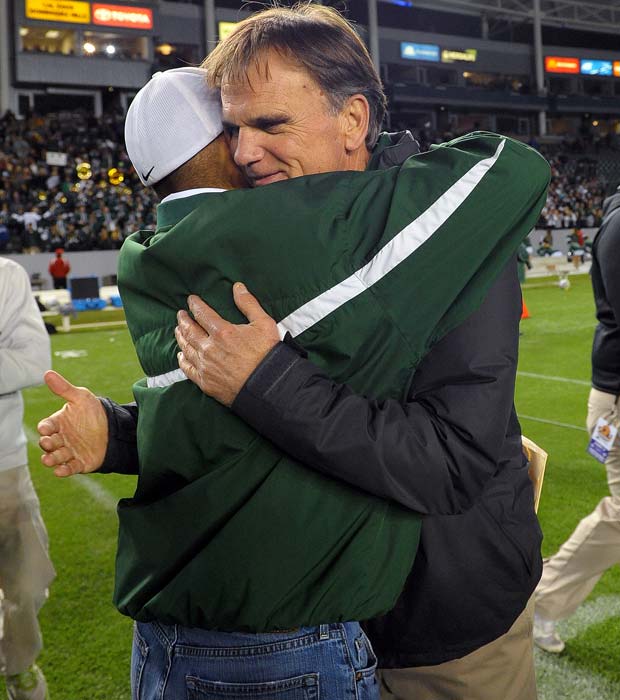 Ladouceur receives a congratulatory hug from Athletic Director Leo Lopez following the Spartans' victory over Centennial in the CIF State Open Division Bowl Game on Dec. 15 at the Home Depot Center.