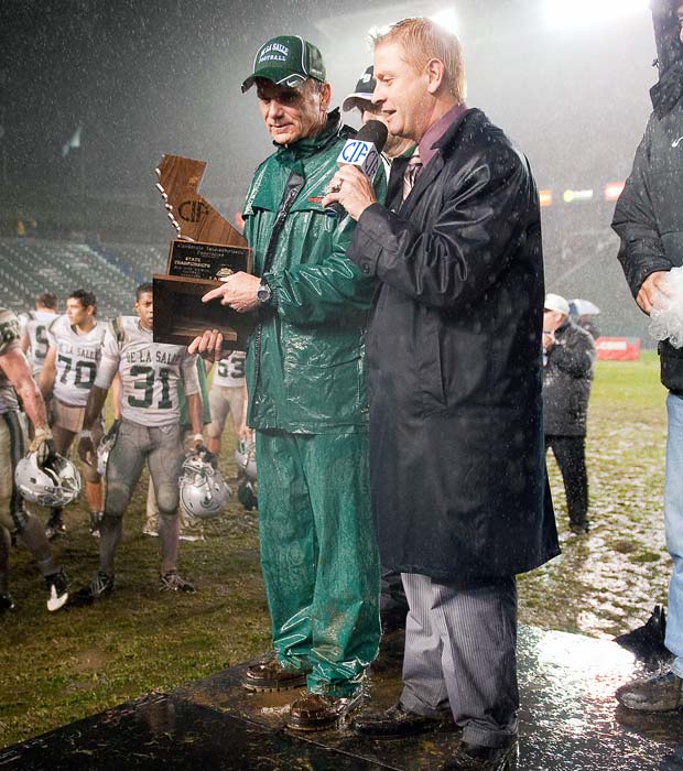 Ladouceur is interviewed by Dan Dibley in a driving rain storm following the Spartans' 2010 victory over Servite in the CIF State Open Division Bowl Game at the Home Depot Center.