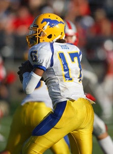 Isaiah Rios played admirably in his
first varsity game, tossing three
touchdown passes.