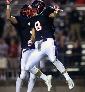 Tyler Petite celebrates with teammate in end
zone.