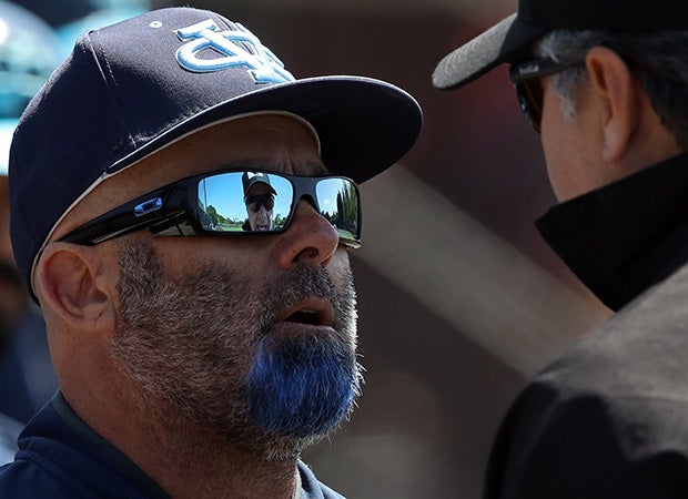 Valley Christian (Calif.) coach John Diatte (left) disagrees with the umpire during a CIF Central Coast Section Open Division quarterfinal playoff game against Sacred Heart Cathedral.