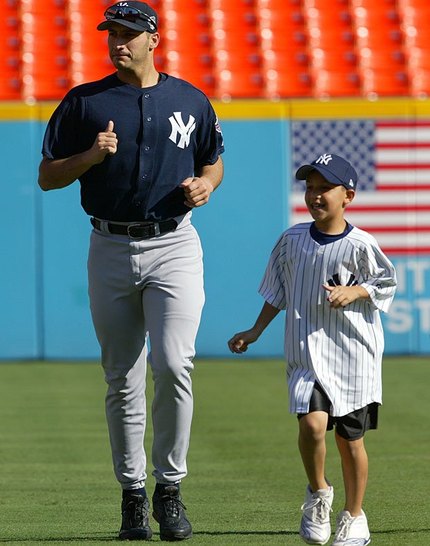 Josh Pettitte running alongside his father, Andy, before Game 3 of the 2003 World Series.