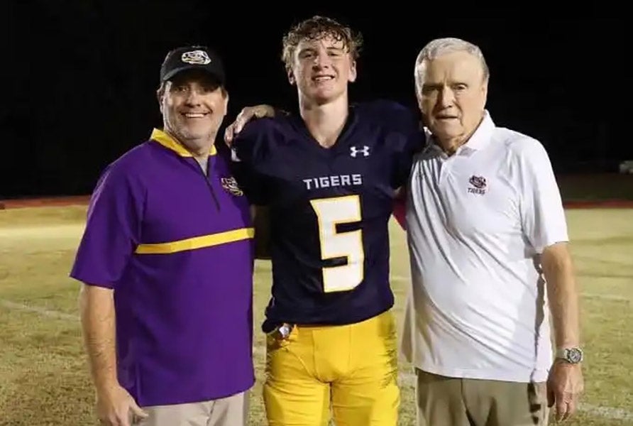 Centreville Academy head coach Bill Hurst (right) with grandson John Austin Sterling (No. 5) and an assistant coach. (PHOTO: Centreville Academy Athletics)