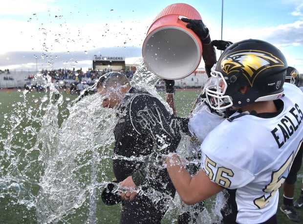 Spring Mountain head coach Aaron Madsen receives a Gatorade soaking by his players while celebrating their victory. 