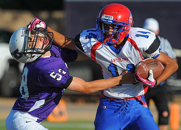 A JV player from Antelope (Wellton, Ariz.) pushes away a defender on Northwest Christian (Phoenix).