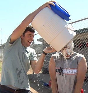 MaxPreps host Chris Stonebraker takes an icewater bath from Nick Porrazzo after getting awhipped cream pie to the face.