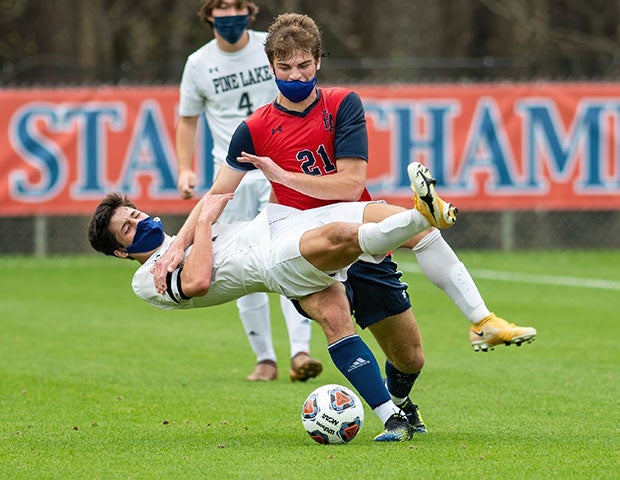 Max Bademian (right) of Franklin Academy (N.C.) and Pine Lake Preparatory's Sutherland Fox Tran collide while battling for control of the ball during the NCHSAA 1A championship game.