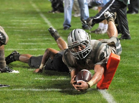 Dunne dives inside the pylon for one of his four touchdowns. 