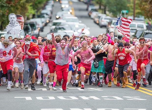 Bergan Catholic (N.J.) fans - the Crusader Crazies - storm up Oradell Avenue before their home football game against Paramus Catholic.