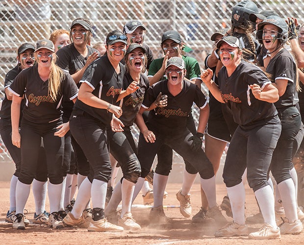 Campo Verde (Ariz.) players excitedly wait at home plate for a teammate to round the bases following a home run in an AIA playoff game against Desert Ridge.