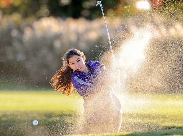 Tottenville (N.Y.) senior Alexander Walsh hits a shot out of a sand trap on the fourth hole at Marine Park Golf Course in Brooklyn during the PSAL semifinals against Cardoza.