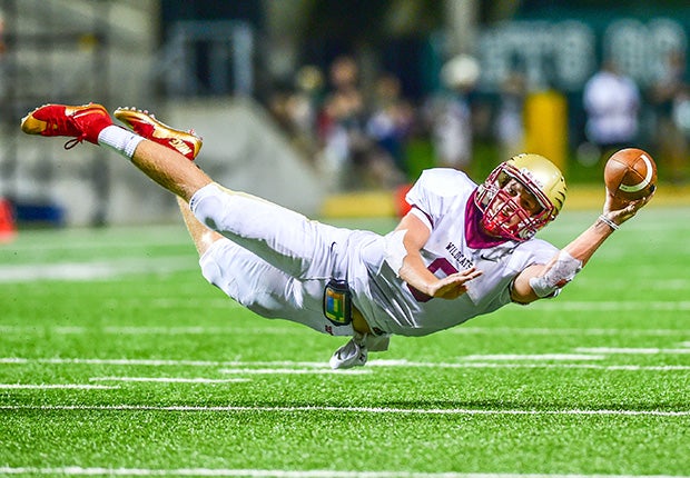 Cypress Woods (Texas) quarterback Bryson Powers dives while attempting a 2-point conversion pass against Cypress Falls.