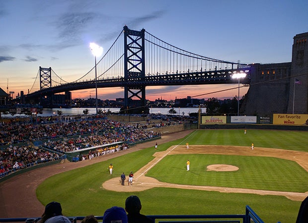 The Ben Franklin Bridge towers over Campbell Field in Camden, N.J., during a baseball game between Barnegat and Gloucester Catholic high schools.