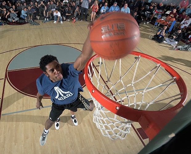 Bishop Gorman (Nev.) guard Christian Popoola leaps over a teammate en route to being crowned the 2015 MaxPreps Holiday Classic dunk champion at Rancho Mirage High School in California.