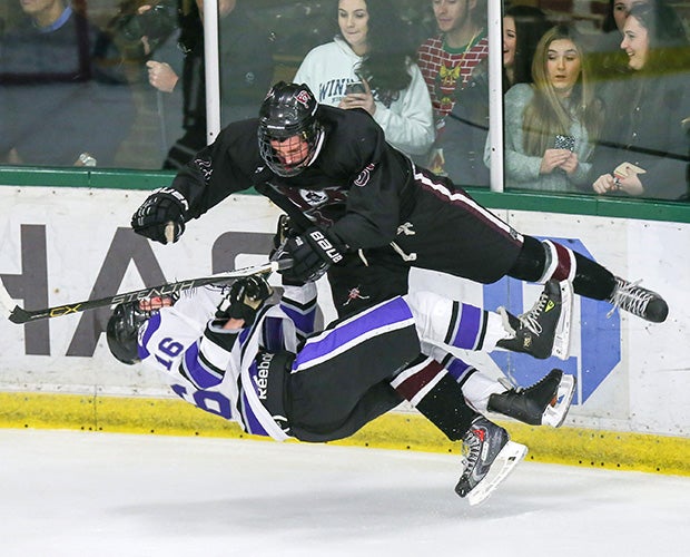 Players from Rumson-Fair Haven and Red Bank Regional collide during a hockey game in New Jersey.