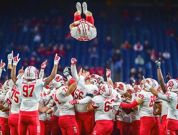 Katy (Texas) players toss teammate Joshua Chiu during a pregame ritual before the start of their UIL quarterfinal playoff game against Manvel.