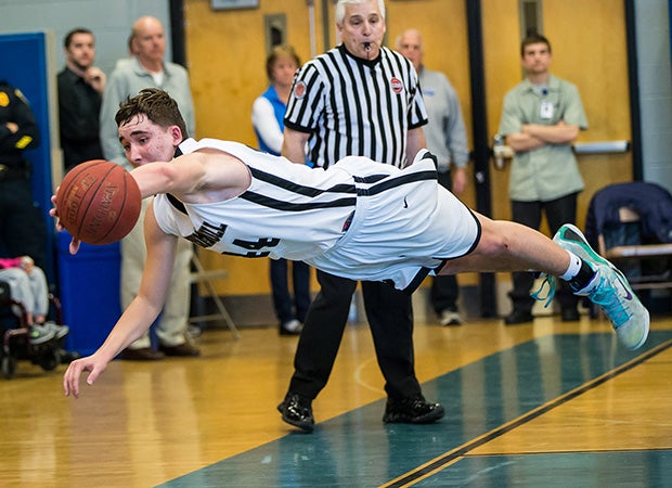 Alex Recker of Trumbull (Conn.) dives in an attempt to keep the ball inbounds during a game against Ridgefield.