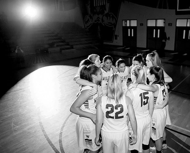 Whitney (Calif.) players huddle up before the start of their game against Cosumnes Oaks.
