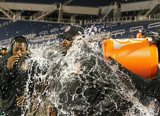 Brooker T. Washington (Fla.) head coach Earl Tillman Jr. is doused with water in the final seconds of his team's victory in the FHSAA Class 4A state football championship game.