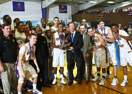 Junior point guard Kasey Hill and head coach Kevin Boyle hold the hardware after Montverde Academy's win over Orlando Christian Prep in the Montverde Academy Invitational final Saturday night.
