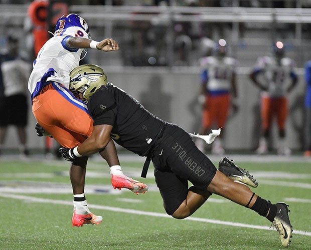 A St. John Bosco defender pressures quarterback Robert Battle. 