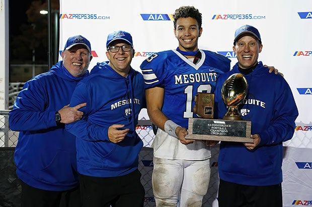 Ty Thompson celebrates with Mesquite coaches after winning the Class 4A state title.