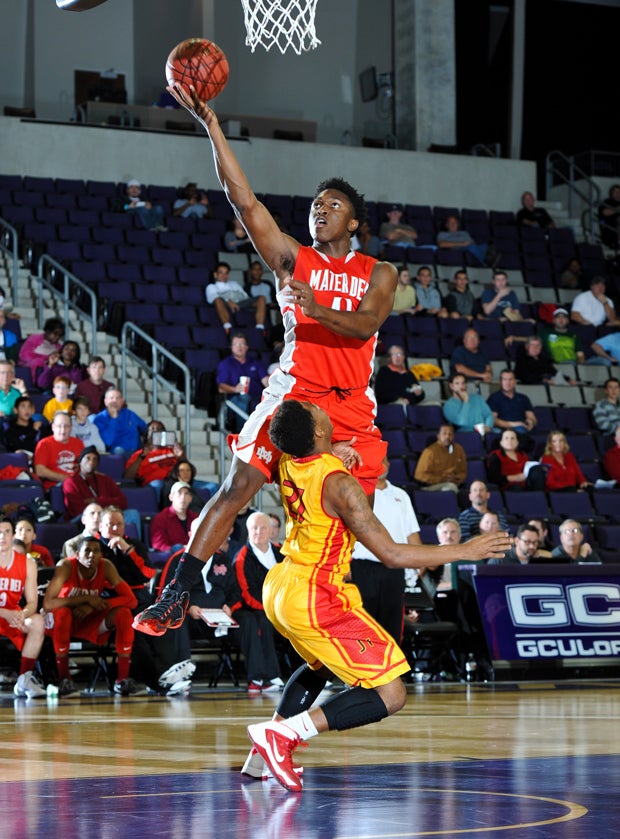 Johnson goes over a Yates opponent for a layup.
