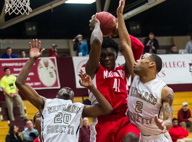 Johnson fights through two Neumann Goretti defenders at the Spalding Hoophall Classic in Massachusetts.