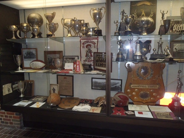 The trophy case at Muskegon is filled with accomplishments from the Big Reds, who have won more football games than any school in Michigan.