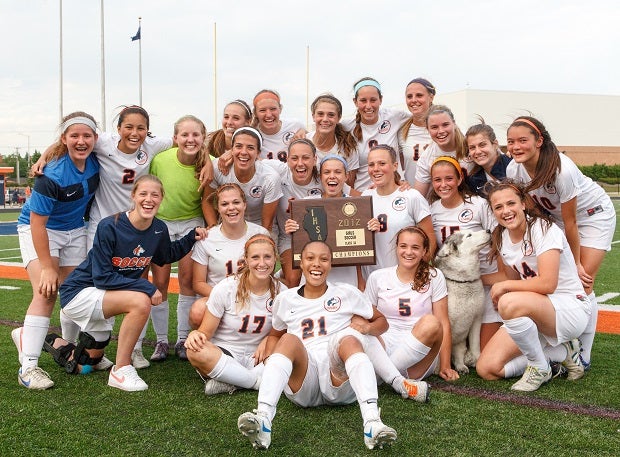 Naperville North (Ill.) celebrates a girls soccer section title in 2012, even having a Husky in the team picture.