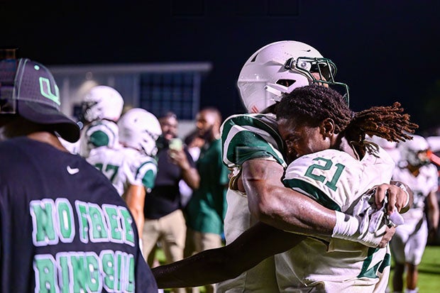 Preseason Sophomore All-American Amari Wallace (21) embraces a teammate after helping Miami Central knock off IMG Academy on Friday night in Bradenton.