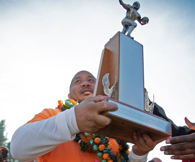 Coach Fred Velasquez holds on to Balboa's elusive first San Francisco Section title trophy since 1984.