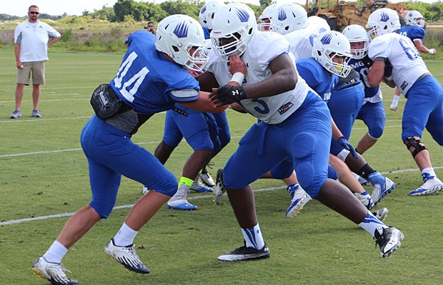 Thomas takes on rising senior tackle Tyree St. Louis during a pass blitz drill in May as Defensive Coordinator Joe Sturdivant (top left) looks on.