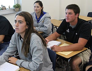 Thomas (right), along with classmates Jacqueline
Simeone (left) and Allie Baer (center) take notes
during AP Calculus.