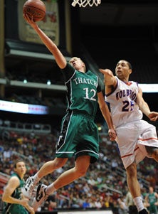 Thatcher's Mitch Goodman (12) makes
acrobatic shot in a roller-coaster
win. 