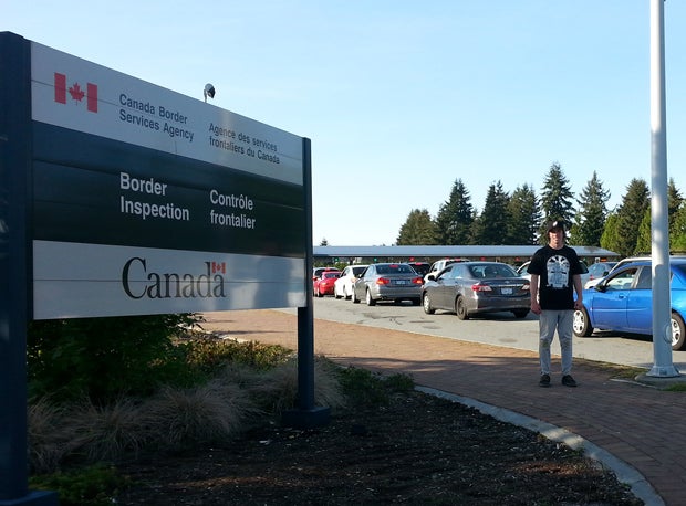 Peltier poses at the entrance into Canada.