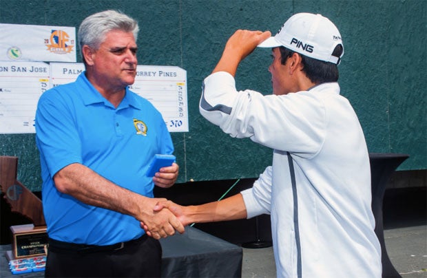 Ron Nocetti shakes hands during a CIF state championship golf event.