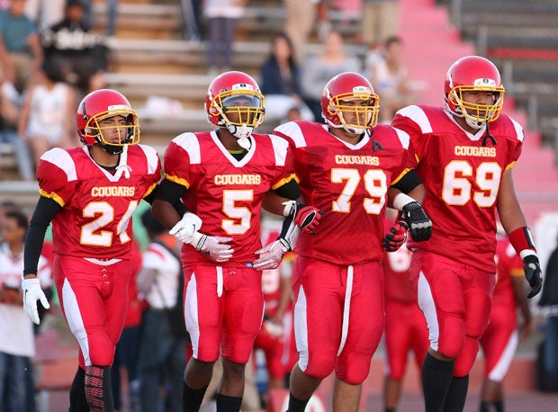 Benjamin Delgado (24), Paris McDaniel (5), Eric Mateos (79) and Sullasi Vaka (69) walk out for the opening coin toss before a game earlier this season with Lynwood.
